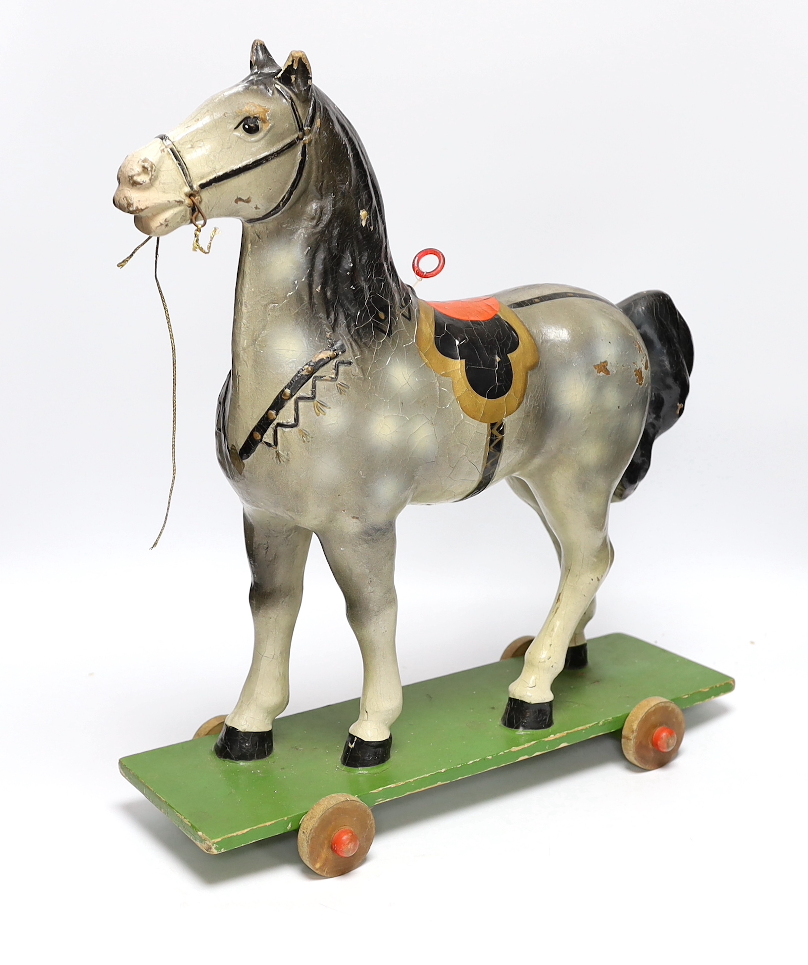 A push along vintage toy horse with pull-string soundbox, 47cm high